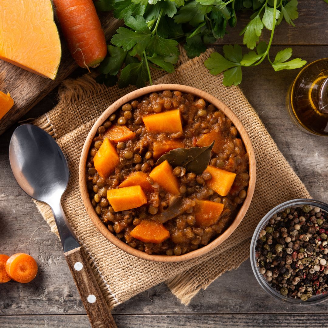 Bowl of hearty lentil and pumpkin stew with herbs, a phytoestrogen-rich meal for menopause.
